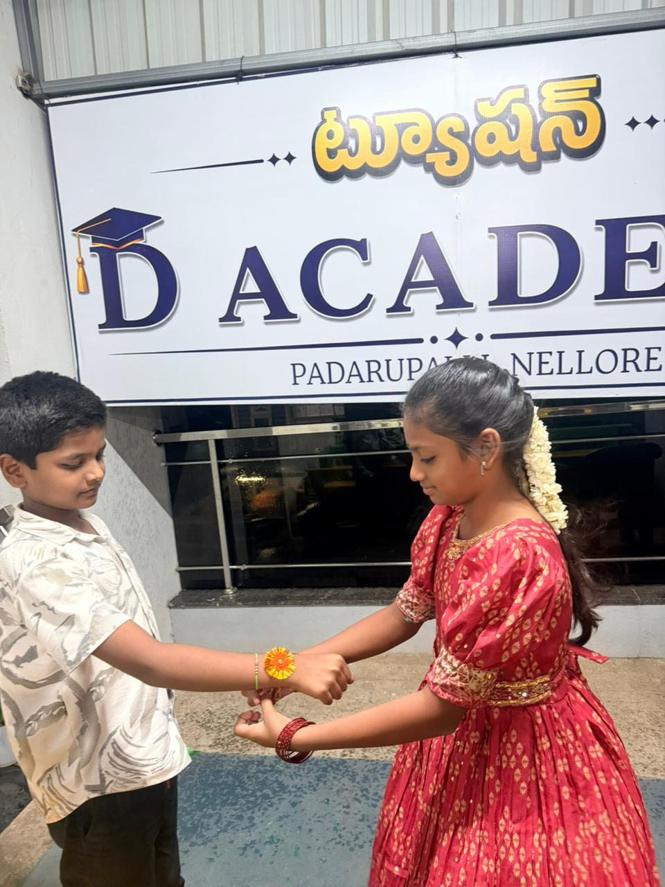 Students celebrating Raksha Bandhan at the D Academy entrance